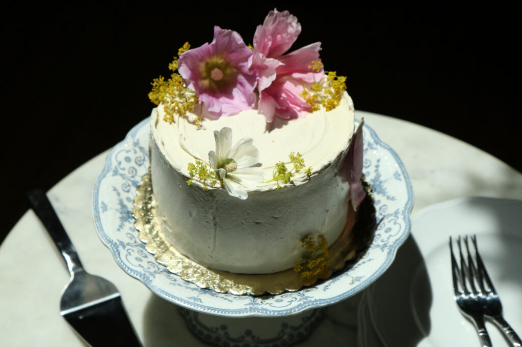 A rustic wedding cake with decorative flowers