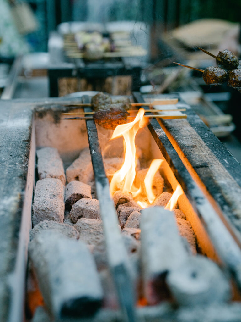 An outdoor grill burns hot