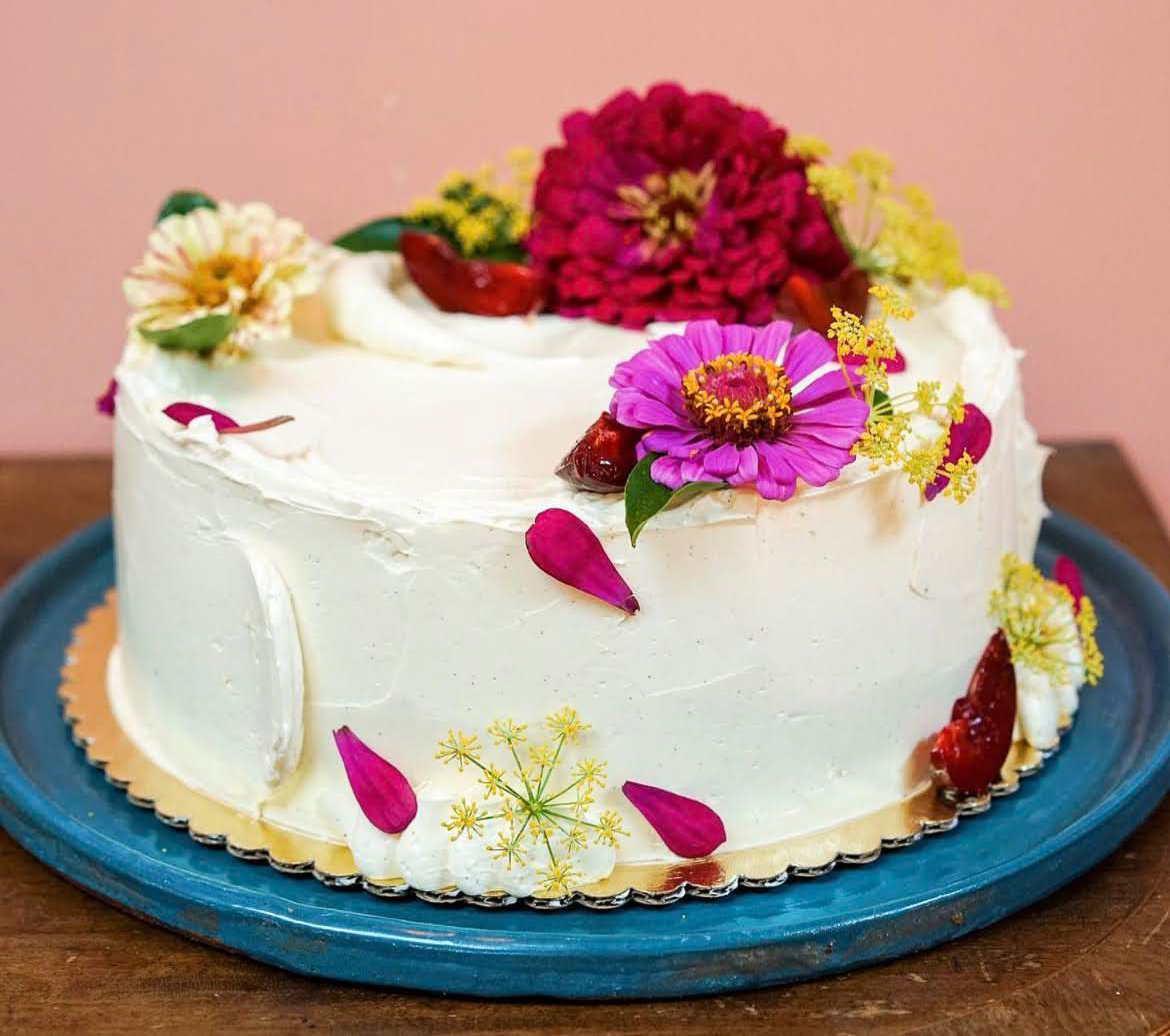 A vanilla buttercream cake topped with fresh flowers